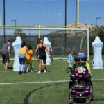 Group of kids near a soccer net learning ball skills